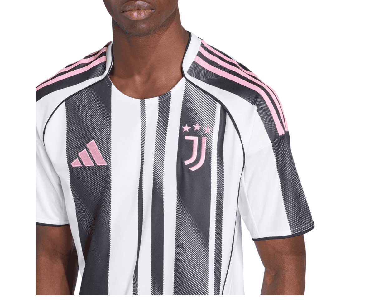 Close-up of a Juventus soccer jersey with black-and-white vertical stripes, pink trim, and crest visible on the chest.
