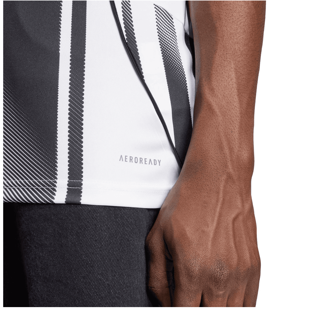 Screenshot_2025-06-19_043504 | UAE SPORT STORE Close-up of a dark-skinned arm beside a white athletic shirt with black vertical stripes and the AEROREADY logo.