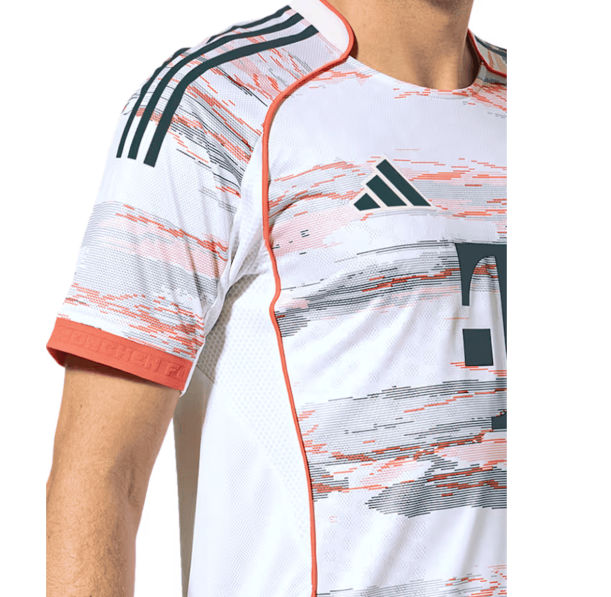 Close-up of a white Adidas sports jersey with orange and black streaks, showing the shoulder and chest area and orange trim.