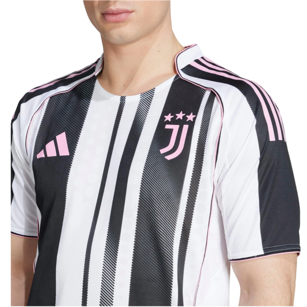 Close-up of a man wearing a white and black striped soccer jersey with pink trim, featuring the Juventus badge with three pink stars on the left chest and a pink Adidas logo.