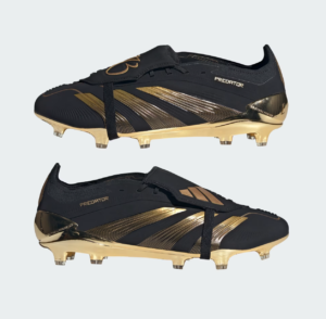 Pair of black and gold Adidas Predator soccer cleats with metallic gold accents on a light background (two shoes shown).