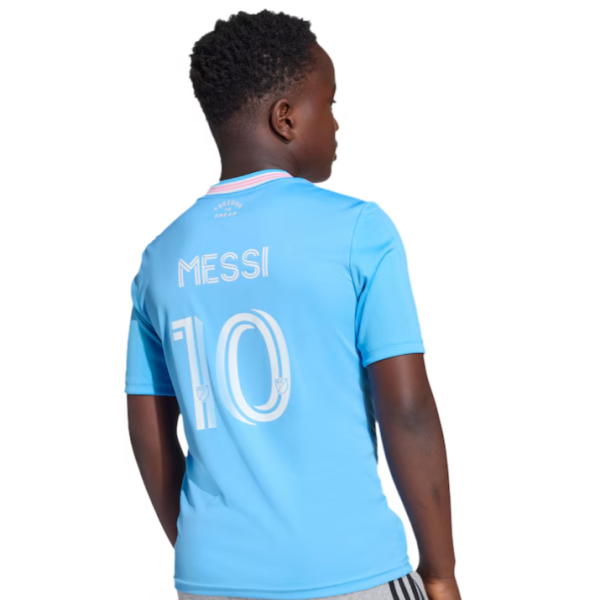 Child wearing a light blue soccer jersey with 'MESSI' and the number 10 on the back, facing away.