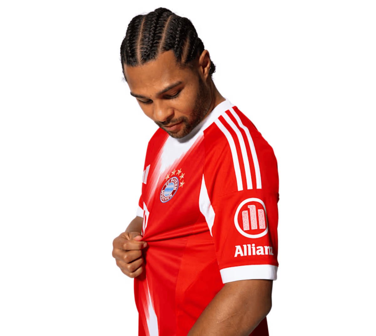 Man with braided hair wearing a Bayern Munich red football jersey, looking down and pulling at his shirt.
