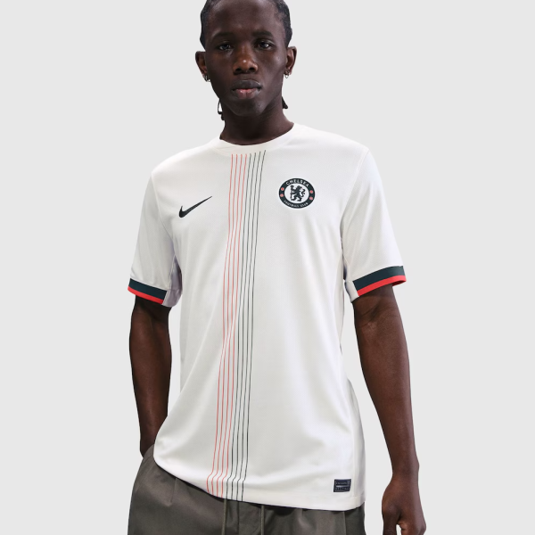 Male model wearing a white Chelsea FC soccer jersey with red and black vertical stripes, Nike swoosh, and club crest on chest.