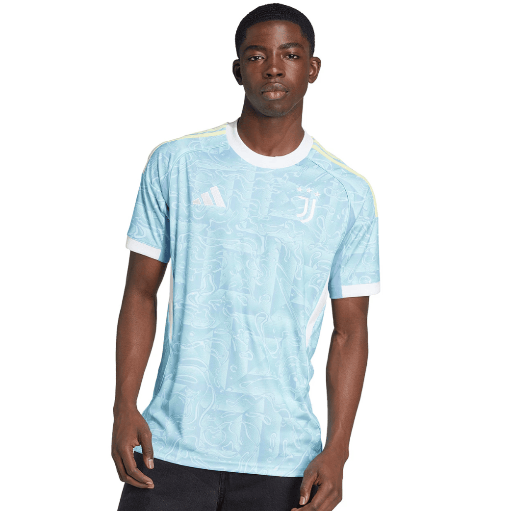 Screenshot_2025-06-23_195437 | UAE SPORT STORE Man wearing a light blue Juventus football jersey with white trim on the collar and sleeves, standing against a plain background