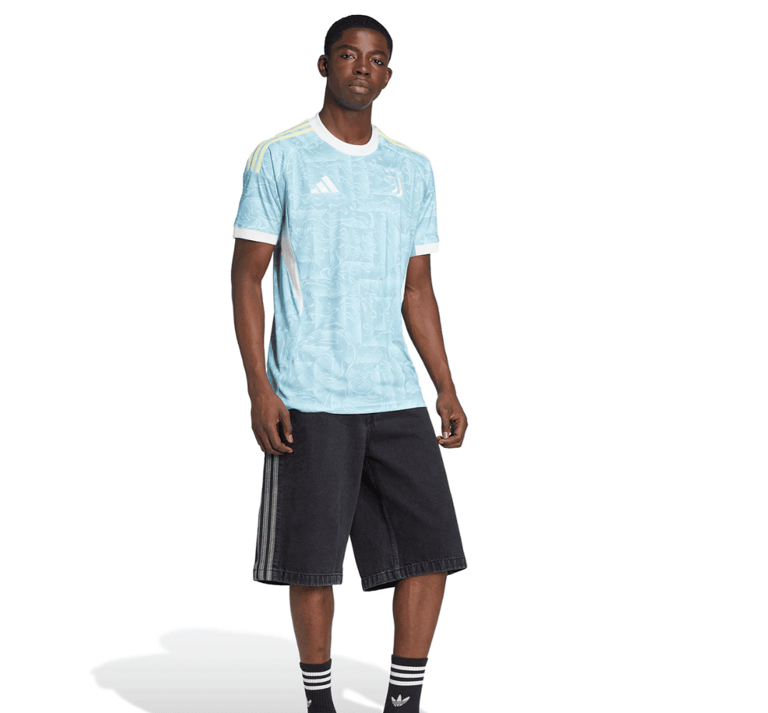Screenshot_2025-06-23_195449 | UAE SPORT STORE Male model wearing a light blue patterned Adidas jersey with white trim and black shorts against a white background.
