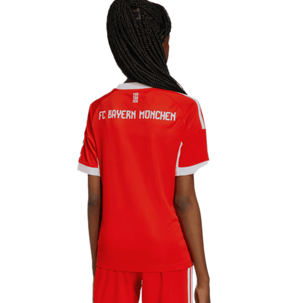 Back view of a person wearing a red FC Bayern Munich football jersey with white trim and matching shorts