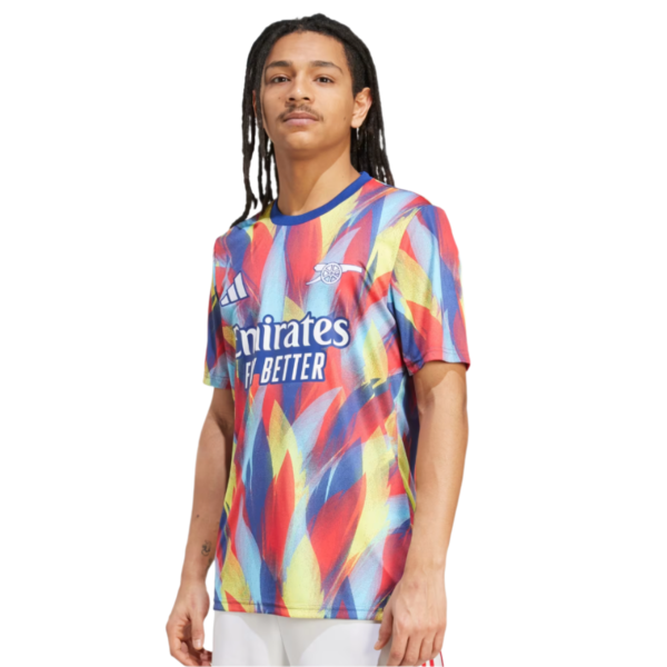 Young man wearing a colorful Arsenal football jersey with the Emirates Fly Better sponsor logo.