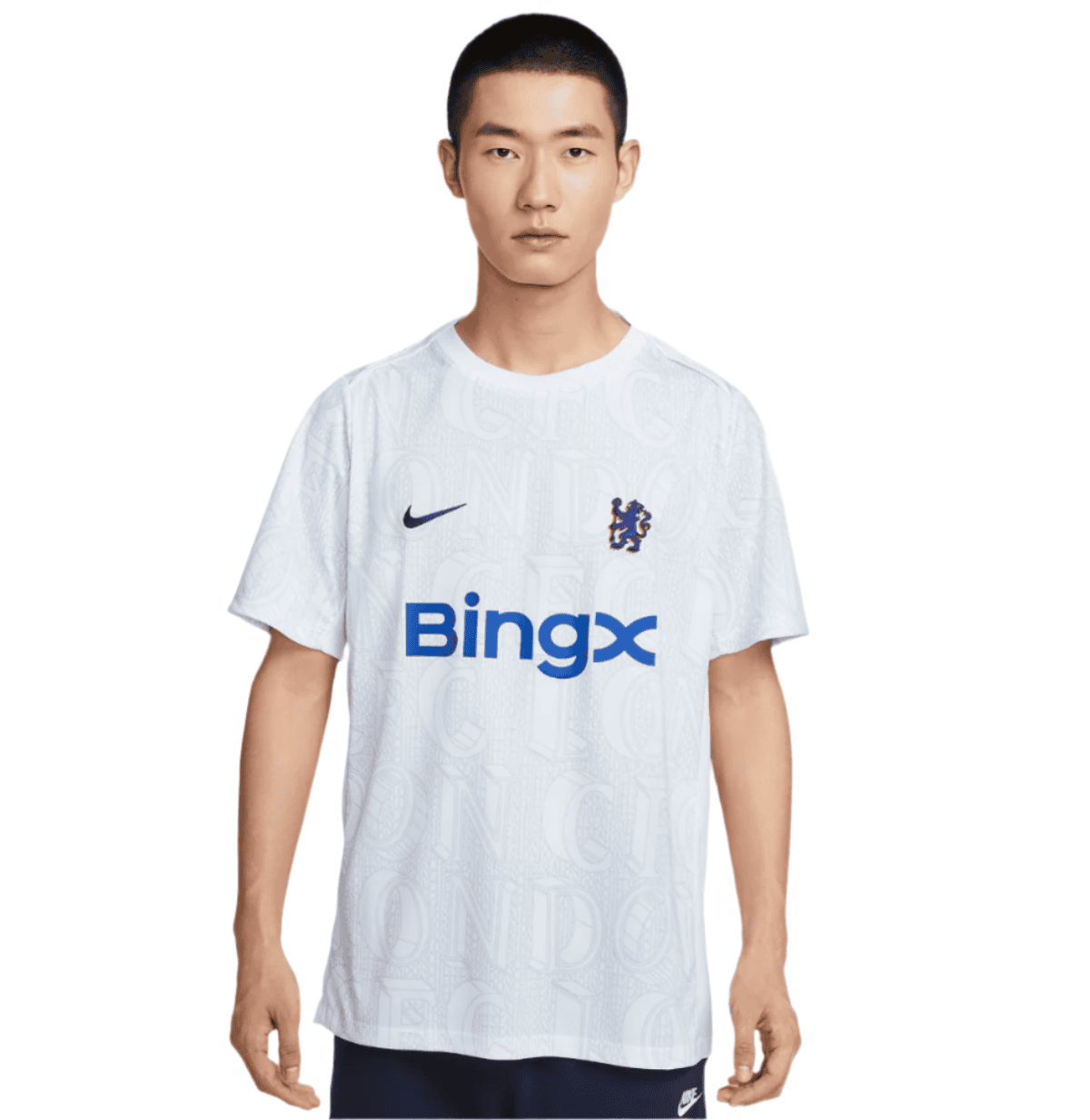 Man standing facing camera in a white Chelsea football jersey with a blue BingX sponsor and Nike logo on the chest.