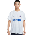 Man standing facing camera in a white Chelsea football jersey with a blue BingX sponsor and Nike logo on the chest.