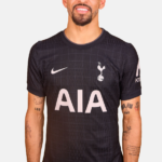 Man wearing a black Tottenham Hotspur football jersey with AIA sponsor across the chest and Nike logo on the right