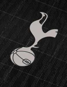 White Tottenham Hotspur logo: a stylized rooster standing on a football on a dark textured surface.