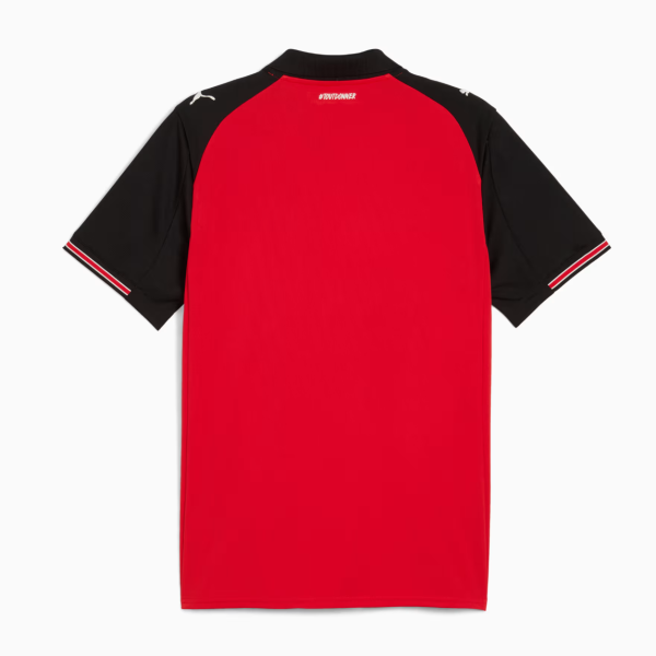 Red sports jersey with black sleeves and white-trimmed cuffs, viewed from the back, featuring a small white hashtag near the neckline (#TOUTDONNER).