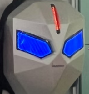 Cosplay helmet with an angular white mask, blue glowing eye slits, and a red vertical LED on the forehead.