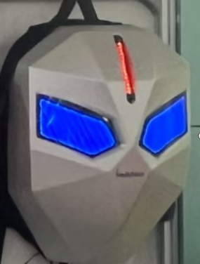 Screenshot_2025-07-26_210711 Cosplay helmet with an angular white mask, blue glowing eye slits, and a red vertical LED on the forehead.