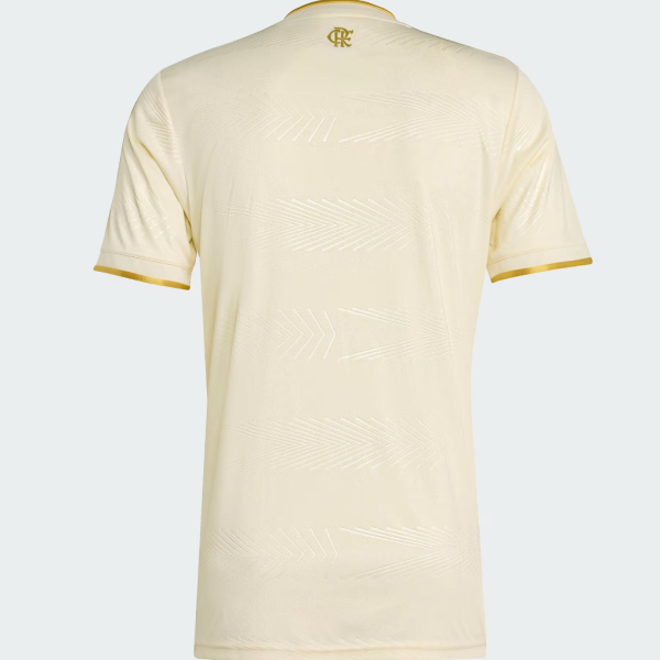 Back view of a cream-colored soccer jersey with gold neck trim and gold sleeve cuffs, subtle chevron texture across the fabric.