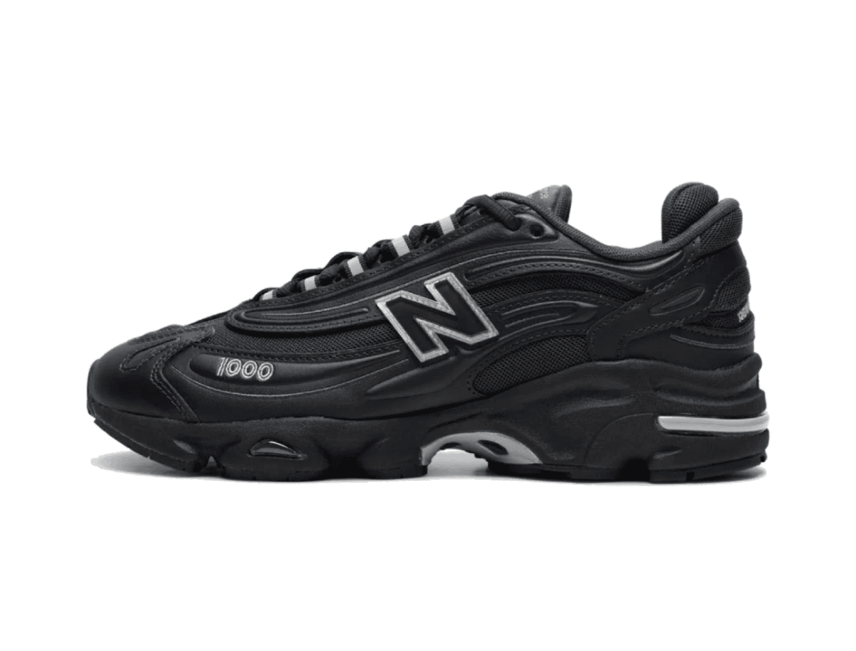 Black New Balance athletic shoe with a chunky sole and silver 'N' logo on the side.