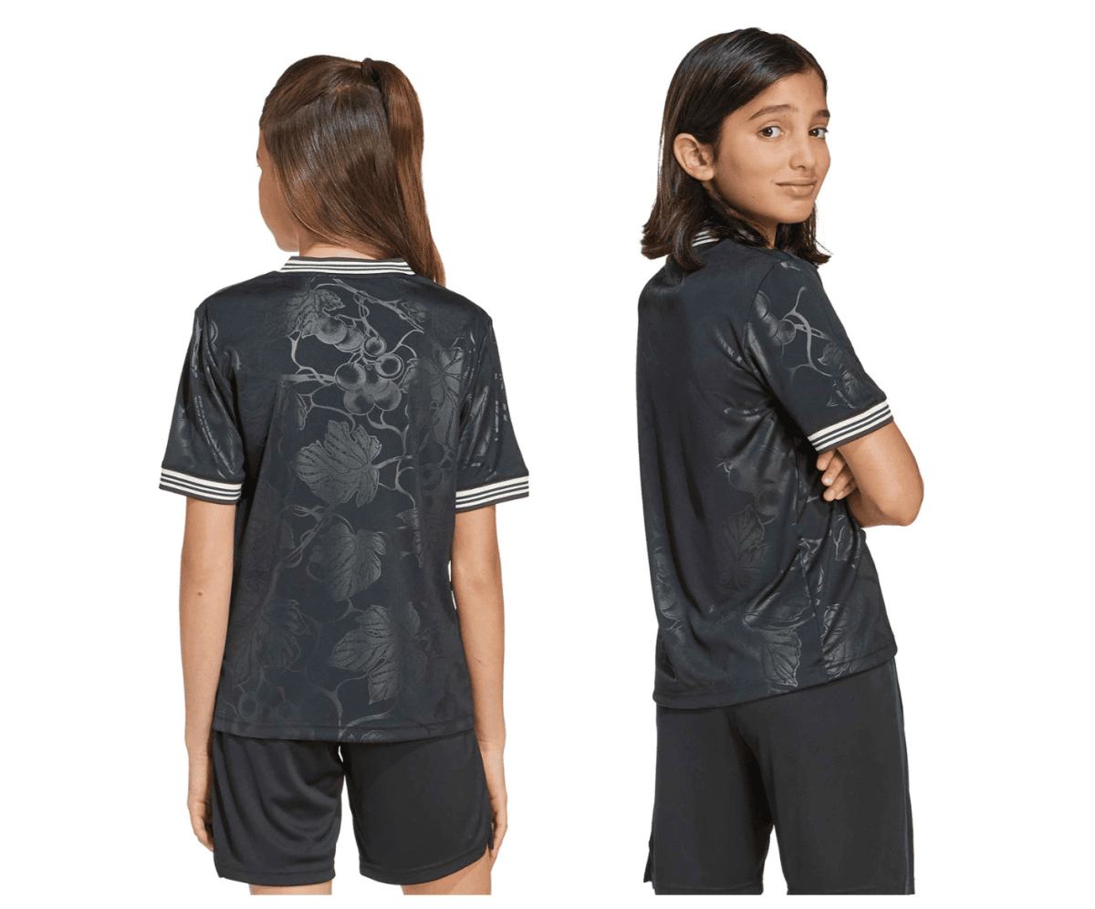 Two young girls model a dark floral-patterned short-sleeve shirt with striped cuffs, shown from back (left) and side (right).