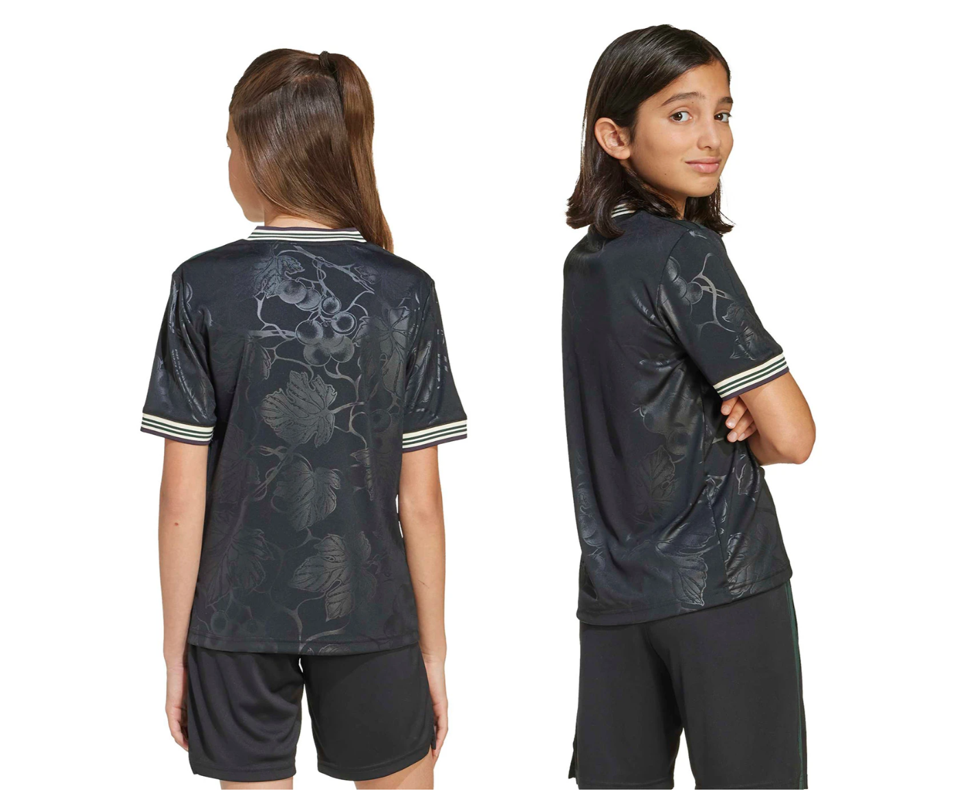 Screenshot_2025-10-12_200022 | UAE SPORT STORE Two young girls model a dark floral-patterned short-sleeve shirt with striped cuffs, shown from back (left) and side (right).