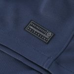 Screenshot_2025-10-12_200509 | UAE SPORT STORE Close-up of dark blue fabric with a small black label reading 'ENGINEERED GARMENTS' sewn onto a pocket seam.