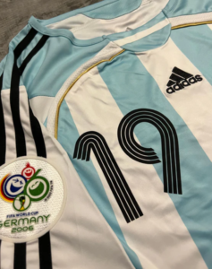 Argentina national soccer jersey with sky-blue and white stripes, number 10, Adidas logo, and 2006 FIFA World Cup Germany patch on the chest area.