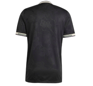 Back view of a black short-sleeve polo with a subtle floral jacquard pattern and cream striped cuffs.