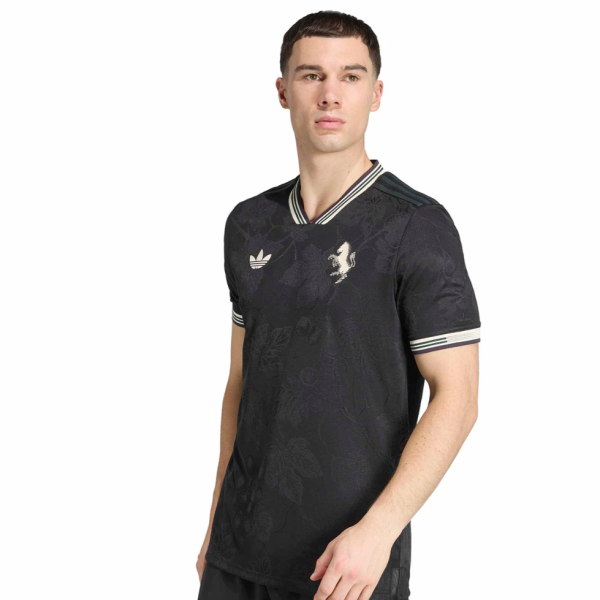 Male model wearing a black floral-pattern polo shirt with striped collar and cuffs; Adidas logo on the chest.