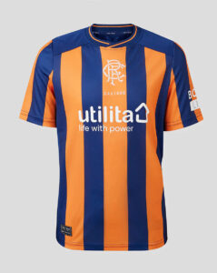 Blue and orange striped soccer jersey with 'utilita' sponsor text on the chest, a crest above it, and short sleeves against a gray background.