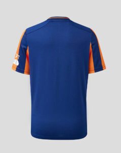Back view of a royal blue sports jersey with orange accents on the sleeves.