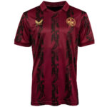 Maroon soccer jersey with dark vertical stripes and a gold wing logo on the chest; club crest on the left front.