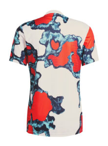 Back view of a short-sleeve shirt with red, blue, and cream abstract camouflage pattern.