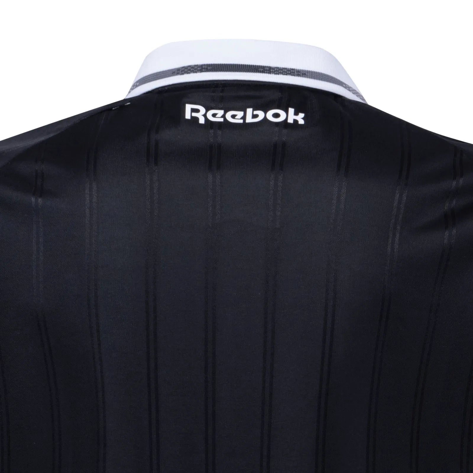 UK | UAE SPORT STORE Back view of a dark, vertically striped jacket or shirt with a white collar featuring the white 'Reebok' logo.