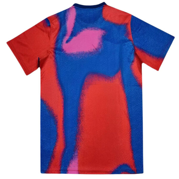 Short-sleeve T-shirt with bold red, blue, and pink abstract pattern.
