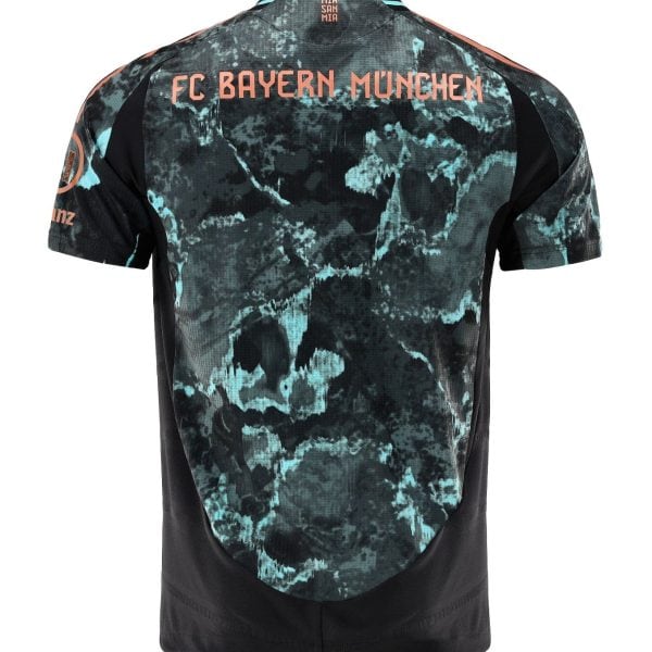 Back view of a teal and black tie-dye FC Bayern München jersey with orange lettering across the shoulders (FC BAYERN MÜNCHEN).