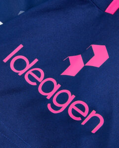 Close-up of a navy blue fabric bag with bright pink logo text reading 'edgegen' and two pink geometric shapes nearby.