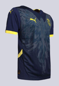 UiOzWiRtwk5wsxf | UAE SPORT STORE Navy blue soccer jersey with yellow Puma logos and crest, featuring yellow sleeve cuffs and a subtle pattern across the front.