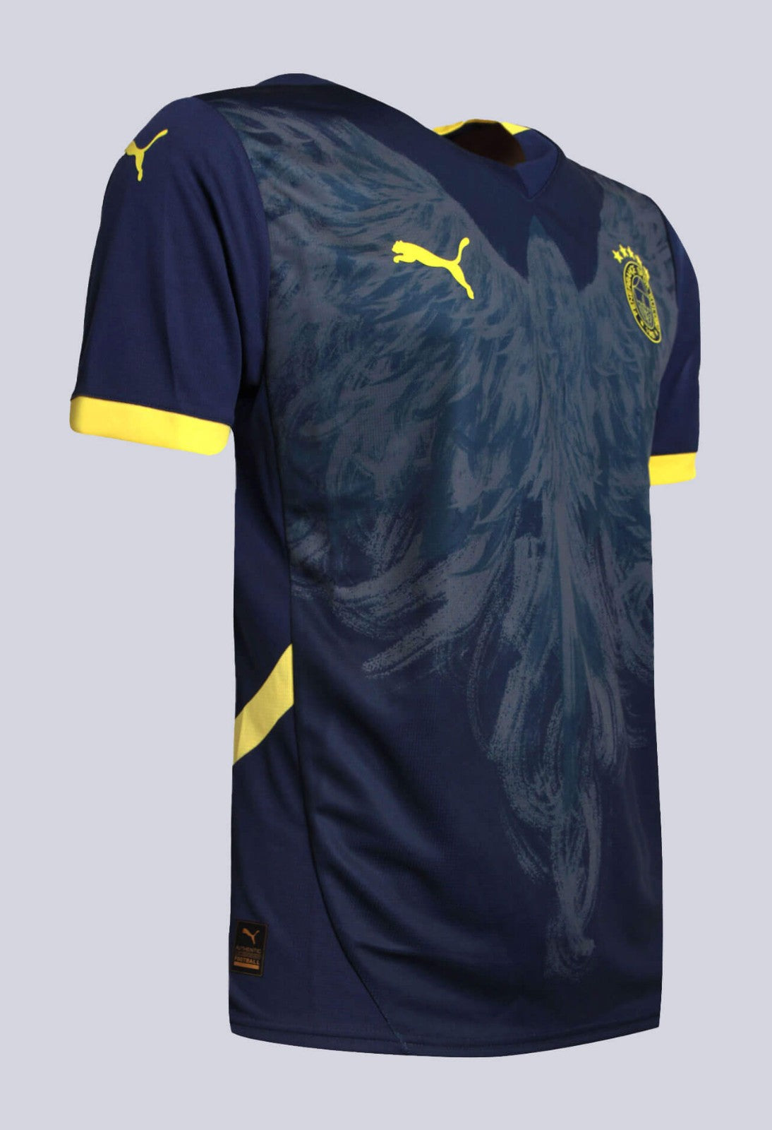 UiOzWiRtwk5wsxf | UAE SPORT STORE Navy blue soccer jersey with yellow Puma logos and crest, featuring yellow sleeve cuffs and a subtle pattern across the front.