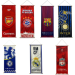Row of eight vertical football banners showing club crests: Arsenal, Bayern Munich, Barcelona, Inter Milan, Chelsea, Real Madrid, and Liverpool.