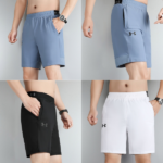 Set of four men's Under Armour athletic shorts in blue, blue-grey, black, and white with elastic waists and side pockets.
