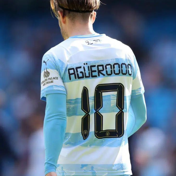 Back view of a soccer player wearing a Manchester City kit with the name 'AGUERO' and number 10 on the jersey.
