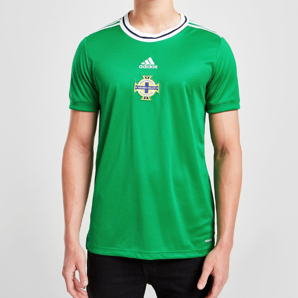 Man wearing a green Ireland national soccer jersey with Adidas logo and crest.