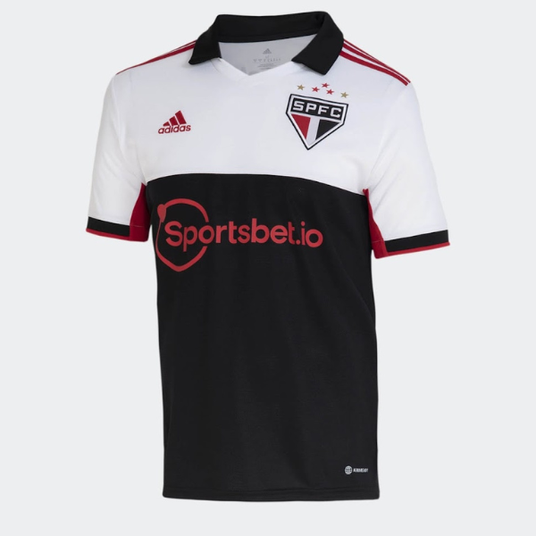 Soccer jersey for São Paulo FC featuring white upper pane, black lower pane with red trim; SPFC crest and Sportsbet.io sponsor.