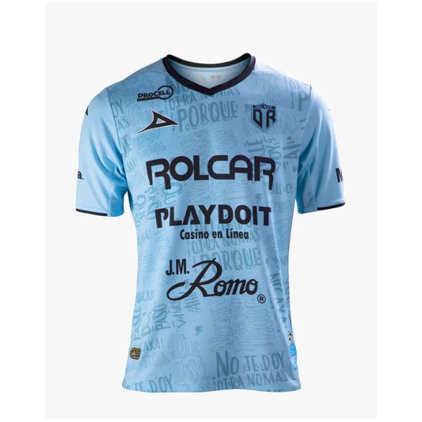 Light blue sports jersey with a dark V-neck and multiple sponsor logos, including ROLCAR, PLAYDOIT, and J.M. Romo, on a white background.