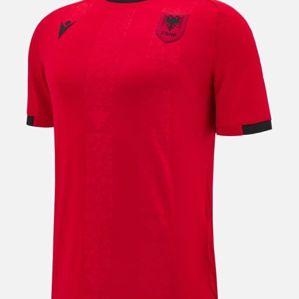 Red soccer jersey with black collar and cuffs, featuring a crest on the left chest and a logo on the right shoulder area.
