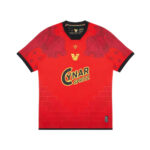 Red soccer jersey with black trim on the collar and cuffs, featuring the yellow Cynar Spritz logo on the chest and a subtle brick pattern at the lower front.