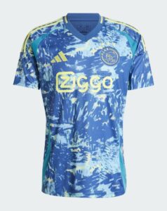 Blue Ajax Amsterdam soccer jersey with yellow Ziggo sponsor logo, crest on chest, and Adidas stripes on shoulders, splash pattern design
