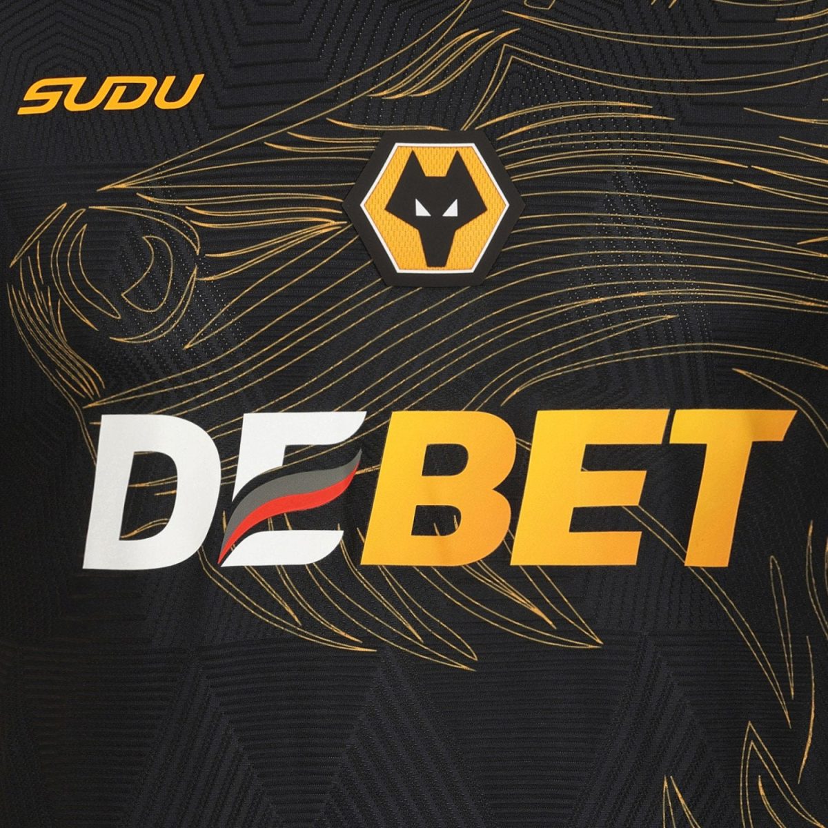 Close-up of a dark jersey with bold white and orange text reading 'DEBET' and a yellow-and-black wolf hex logo above it.