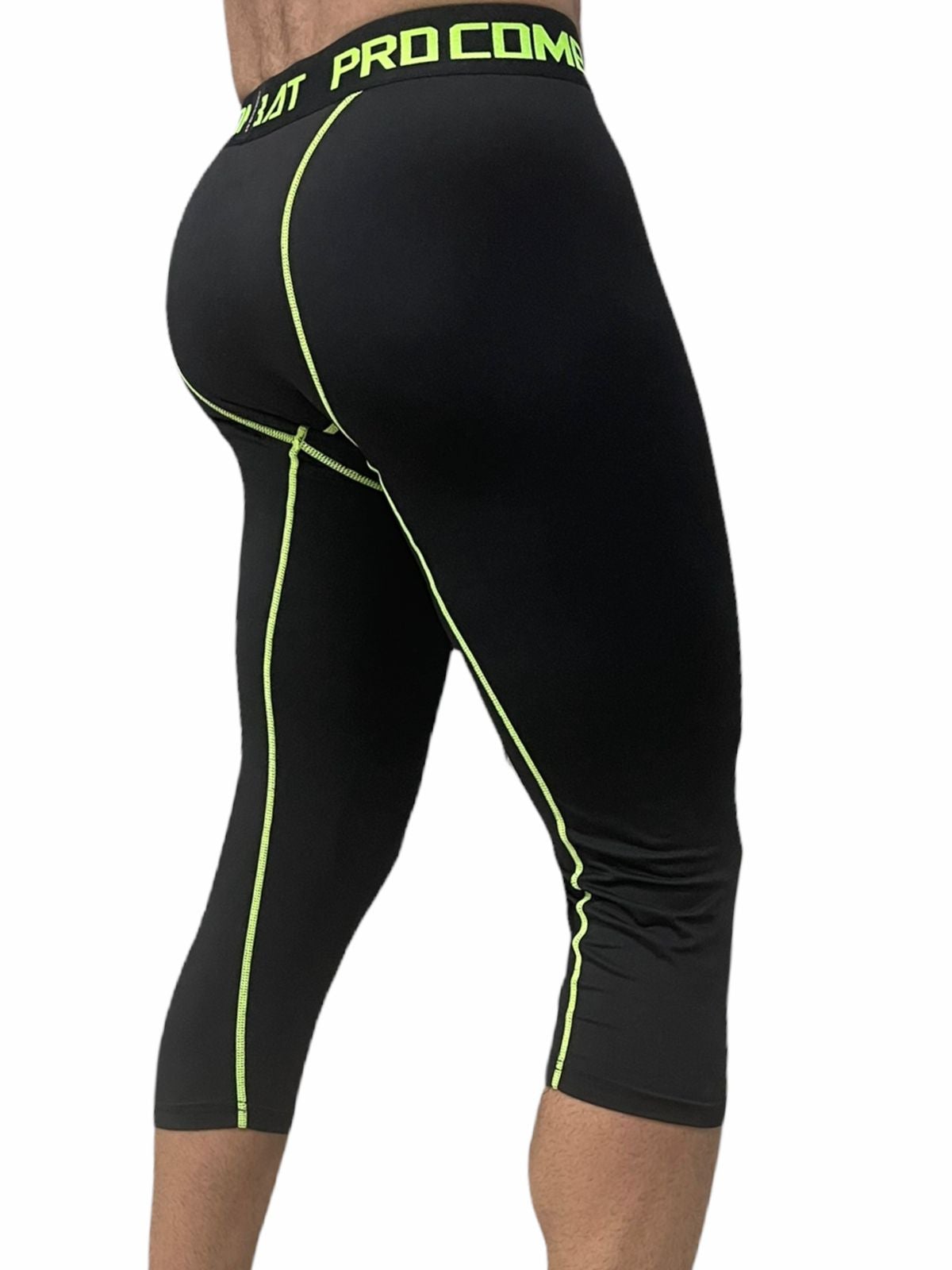 WhatsAppImage2021-09-16at5.22.14PM_223a0030-6bf1-49bd-ba82-16506e53d8e4 | UAE SPORT STORE Black athletic tights with neon green piping along the side seams and waistband; waistband shows 'PRO COMBAT' branding.