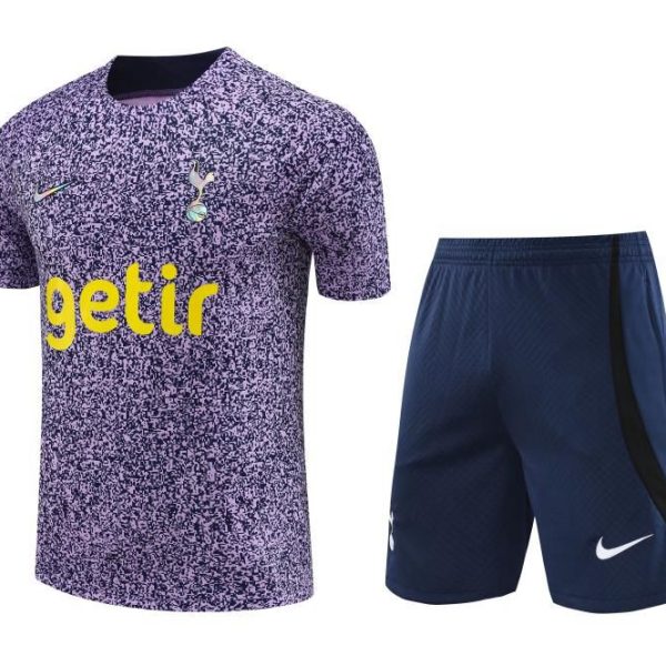 Tottenham Hotspur away kit: purple speckled jersey with yellow 'getir' sponsor and club crest, paired with navy shorts with white Nike swoosh.