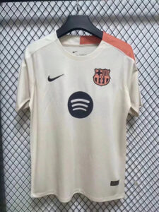 White FC Barcelona football jersey on a hanger, featuring the Nike swoosh, club crest, and Spotify sponsor logo on the front.